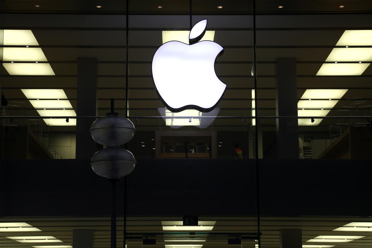 An Apple logo is illuminated at a store in Munich, Germany. 