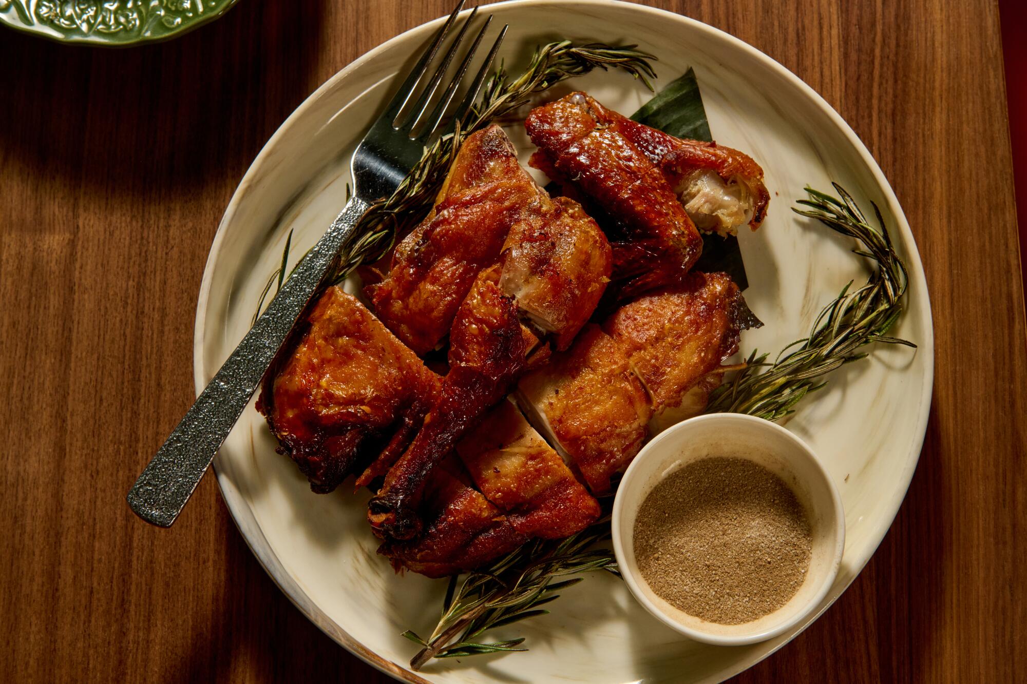 Chicken in banana leaf with crispy skin.