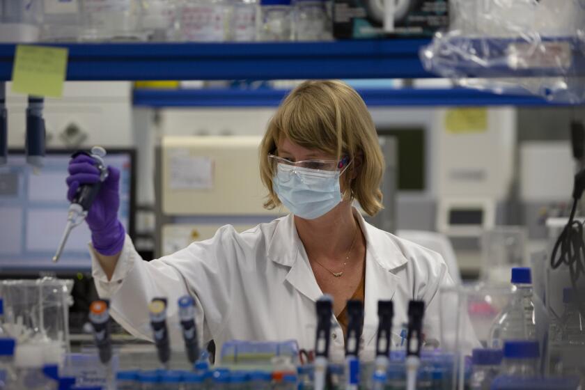 A lab technician works during research on coronavirus, COVID-19, at Johnson & Johnson subsidiary Janssen Pharmaceutical in Beerse, Belgium, Wednesday, June 17, 2020. Janssen Pharmaceutical hopes to begin clinical trials on a potential vaccine for COVID-19 in the middle of the summer. (AP Photo/Virginia Mayo)