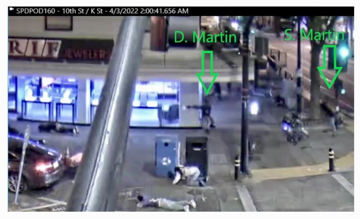 Suspect angles his firing arm downward toward rival gang members in the Sacramento shootout.