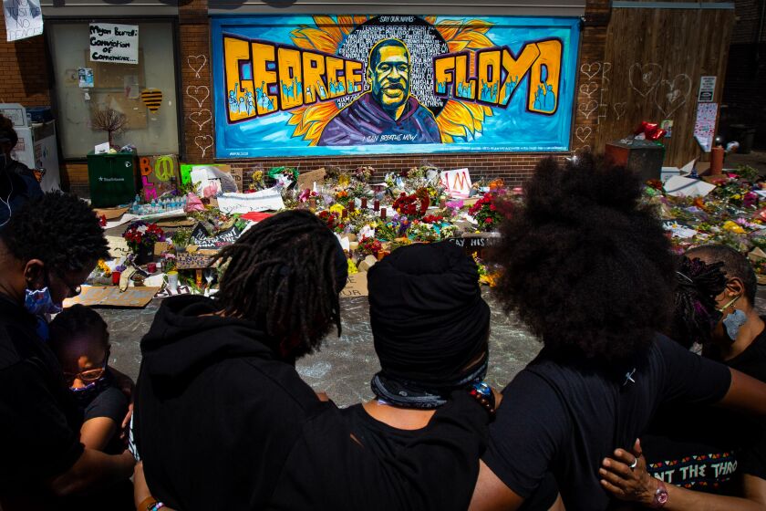 MINNEAPOLIS , MINNESOTA - JUNE 01: The Holloway family pay their respects at the makeshift memorial at Cup Foods where George Floyd was killed by a Minneapolis police officer on Monday, June 1, 2020 in Minneapolis, Minnesota.