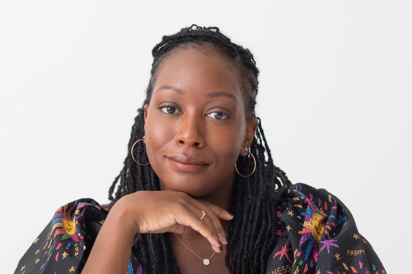 Portrait of Sarai Johnson seated and smiling at camera 