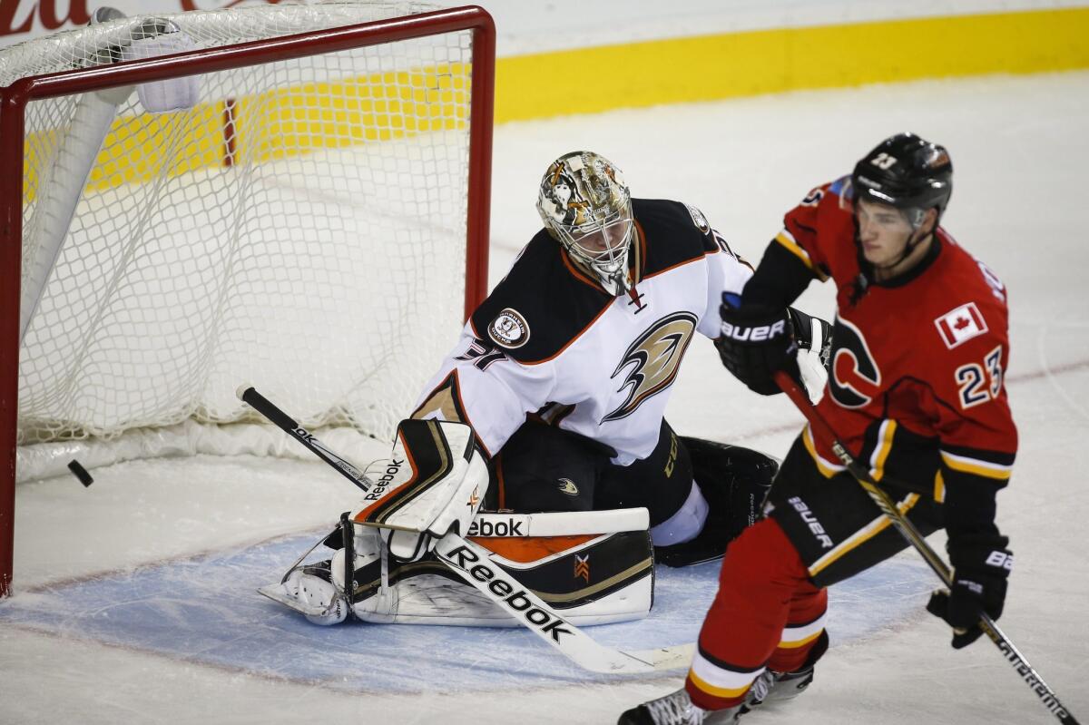 Ducks goalie Frederik Andersen, left, can't stop the puck as Calgary's Sean Monahan scores the winning goal Nov. 18 in a shootout.