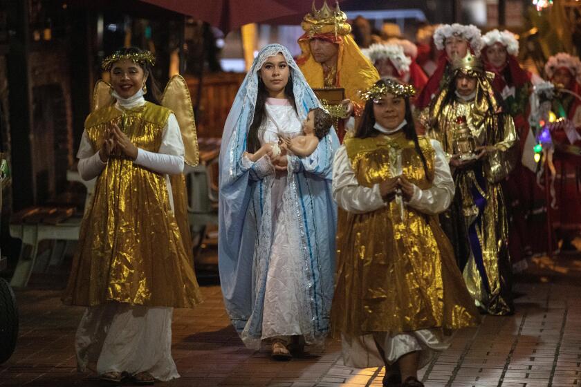The Olvera Street Merchants Assn. Foundation's Dia de los Reyes procession at Olvera Street Thursday, January 6, 2022. The procession ended with games, prizes, champurrado and rosca de reyes bread. The event celebrates the visitation of the three wise men/kings to the infant Jesus shortly after his birth.