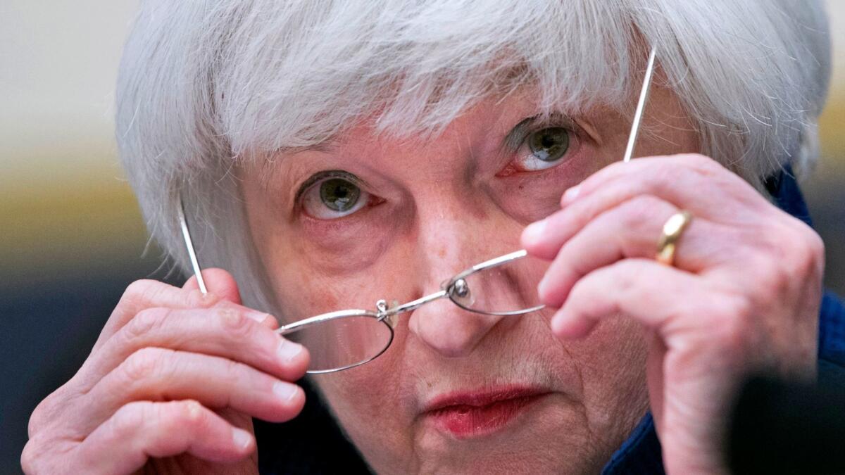 Federal Reserve Chairwoman Janet L. Yellen removes her glasses as she testifies on Capitol Hill in Washington in July.