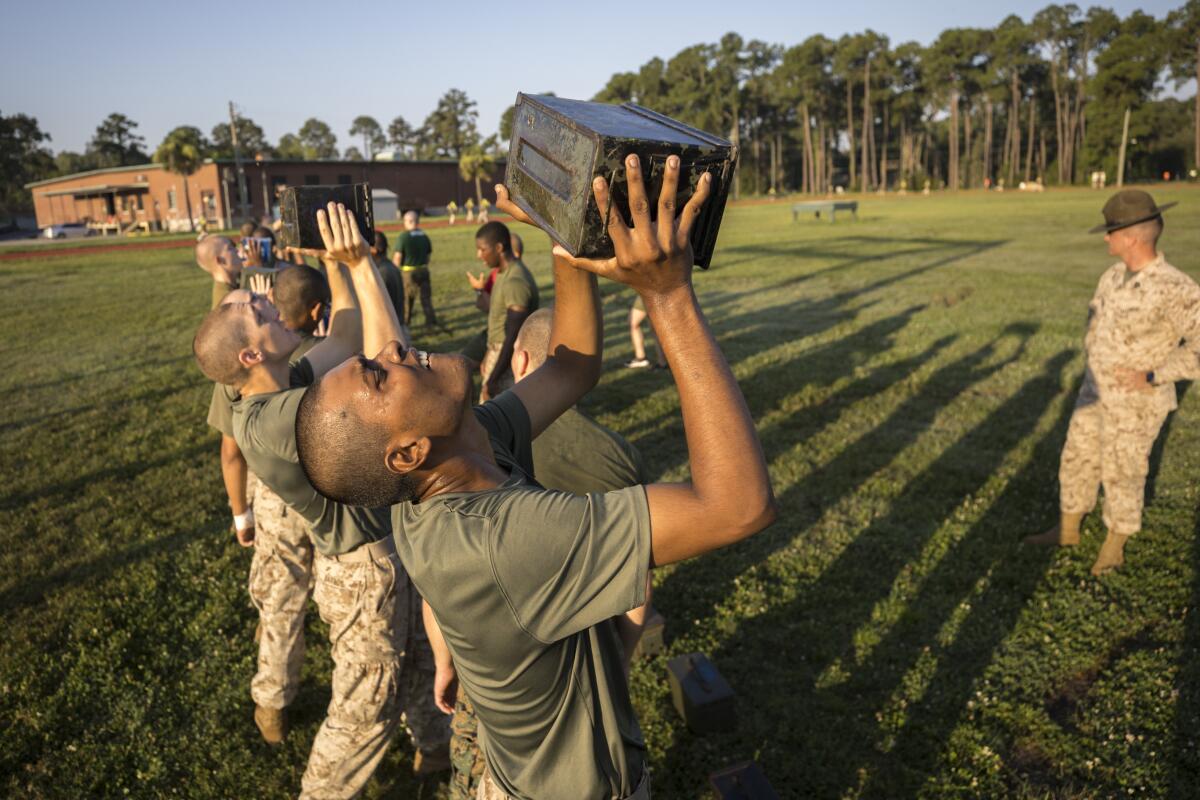 U.S. Marine Corps recruits train with weighted ammo cans 