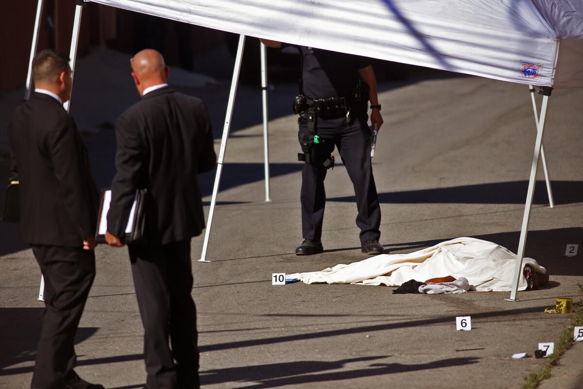 Authorities at the scene where a woman was shot during a confrontation with police in an alley in Baldwin Hills.
