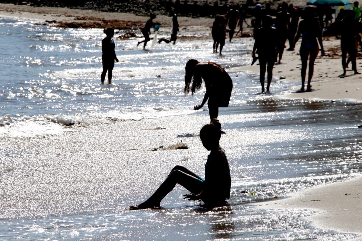 A girl cools off on the beach in Los Angeles.