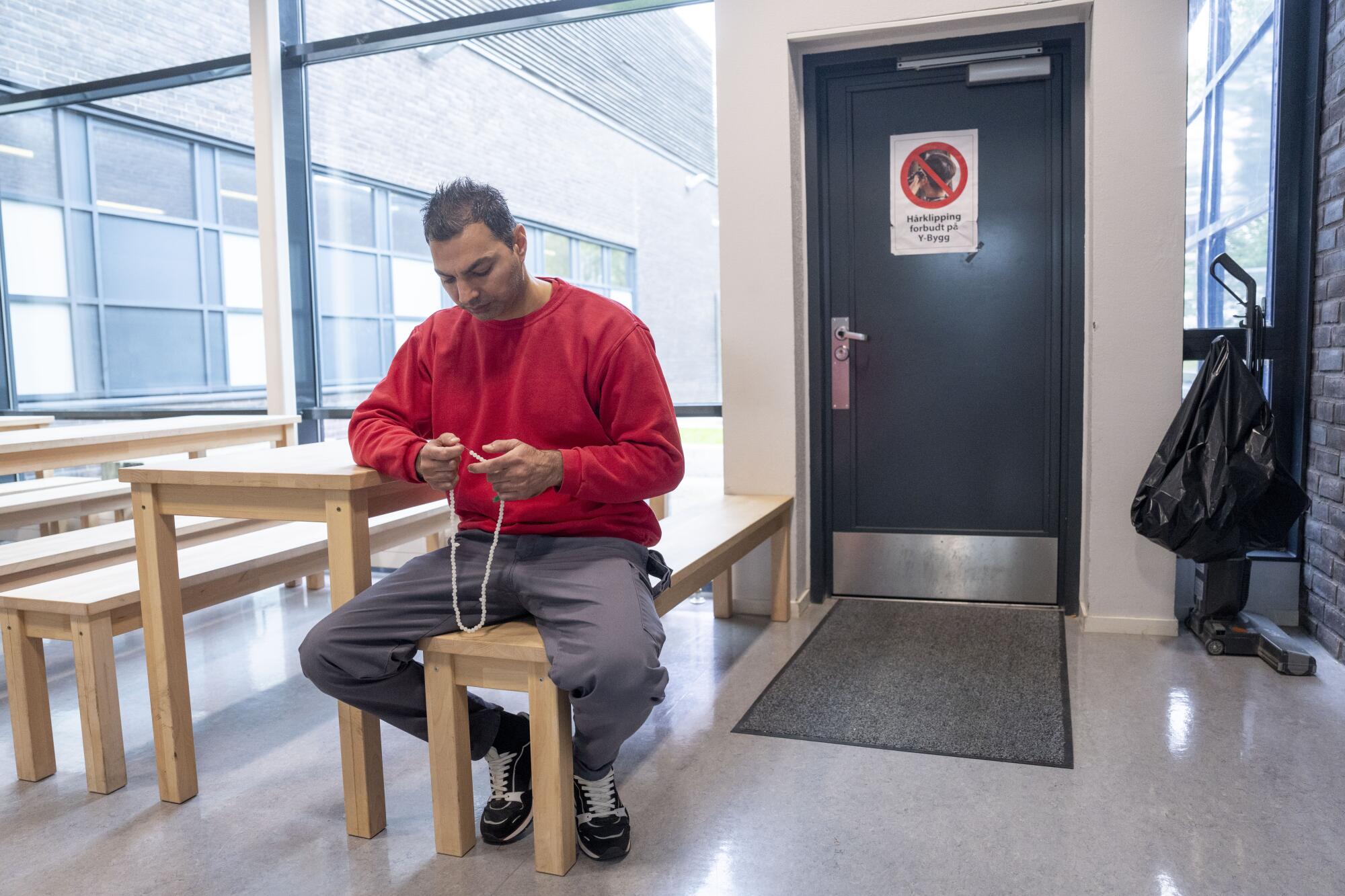 An inmate sits at a table at Halden prison.