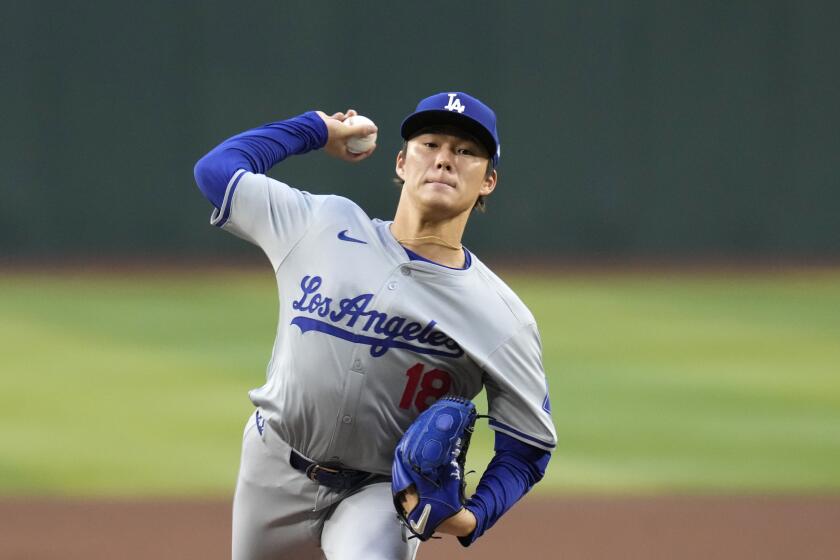 Los Angeles Dodgers starting pitcher Yoshinobu Yamamoto, of Japan, warms up during the first inning of a baseball game against the Arizona Diamondbacks Wednesday, May 1, 2024, in Phoenix. (AP Photo/Ross D. Franklin)