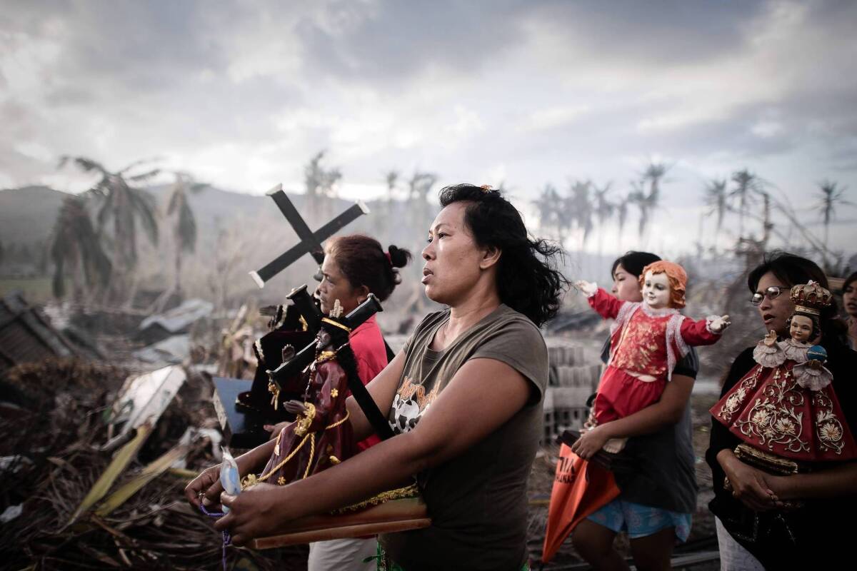 Filipinos walk in a religious procession in Tolosa, about 20 miles south of Tacloban on the island of Leyte, more than a week after Typhoon Haiyan devastated the area.