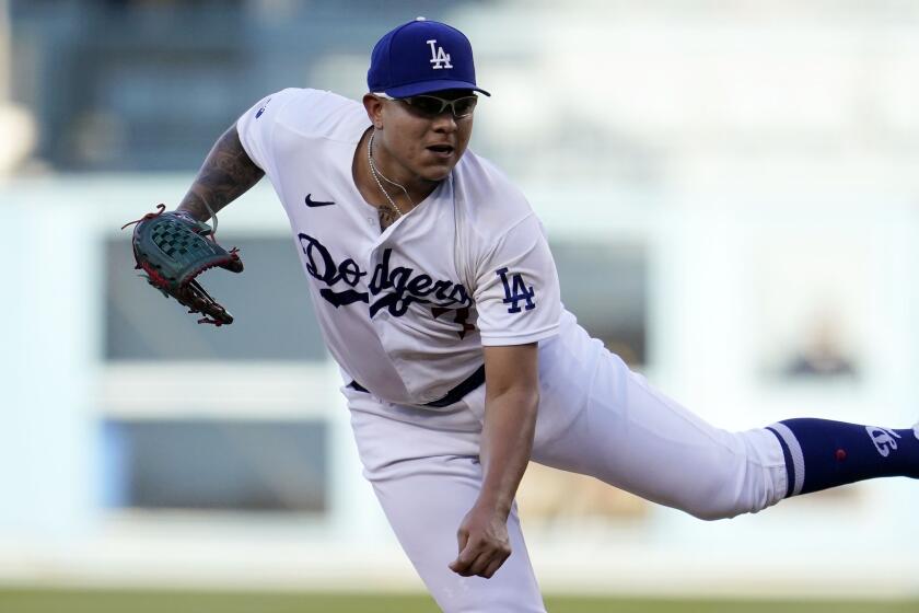 Los Angeles Dodgers starting pitcher Julio Urias throws to a San Diego Padres batter.