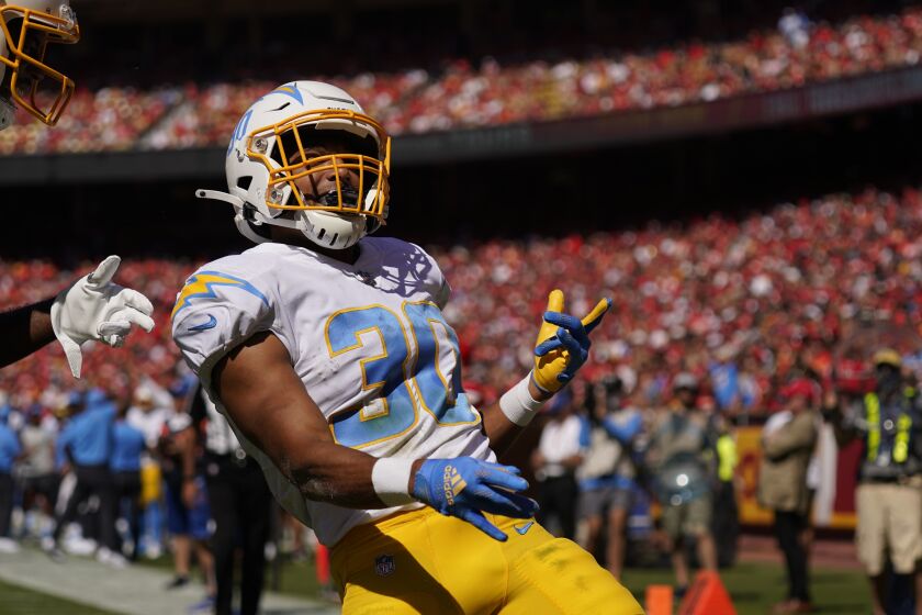 Los Angeles Chargers' Austin Ekeler (30) celebrates a touchdown run during the first half of an NFL football game against the Kansas City Chiefs, Sunday, Sept. 26, 2021, in Kansas City, Mo. (AP Photo/Charlie Riedel)