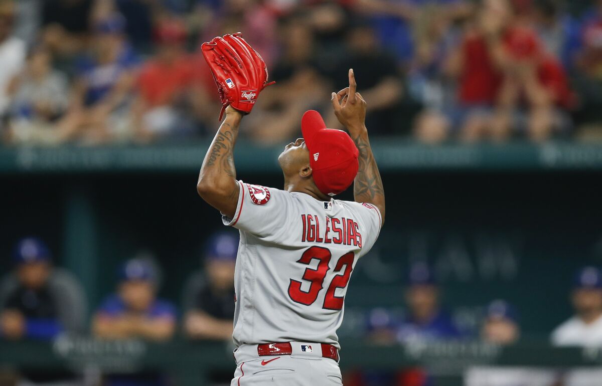 Angels relief pitcher Raisel Iglesias points skyward in celebration of a 5-0 win over the Texas Rangers