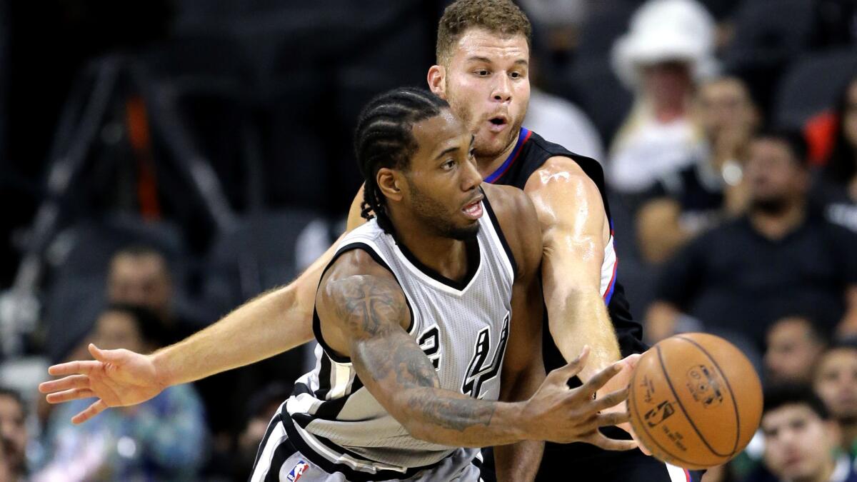 Clippers forward Blake Griffin pressures Spurs forward Kawhi Leonard during the first half Friday night.
