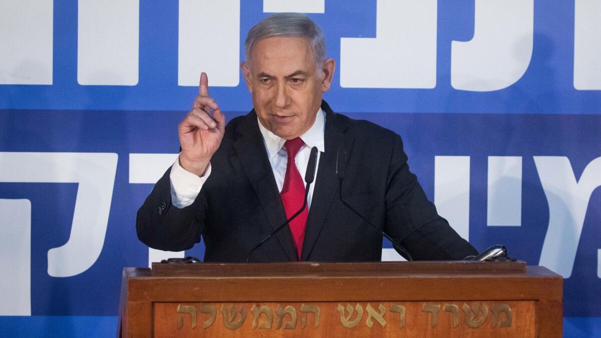 Israeli Prime Minister Benjamin Netanyahu gives a statement to reporters Feb. 28 on the attorney general's decision to indict him on charges of bribery, fraud and breach of trust, pending a hearing.