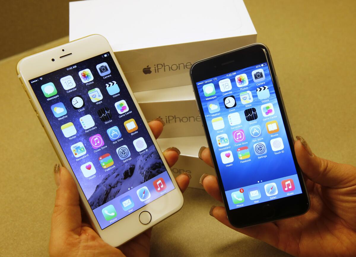 Apple's iPhone 6, right, and iPhone 6 Plus are shown at a Verizon store in Orem, Utah.