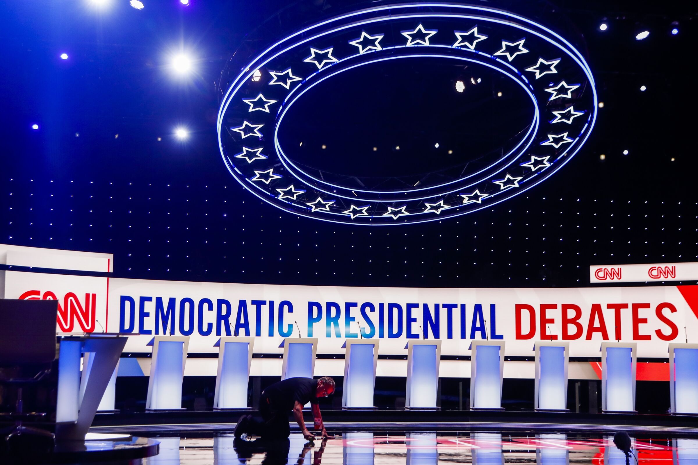 A worker gets the stage ready for the Democratic primary debate hosted by CNN at the Fox Theatre in Detroit on July 30.