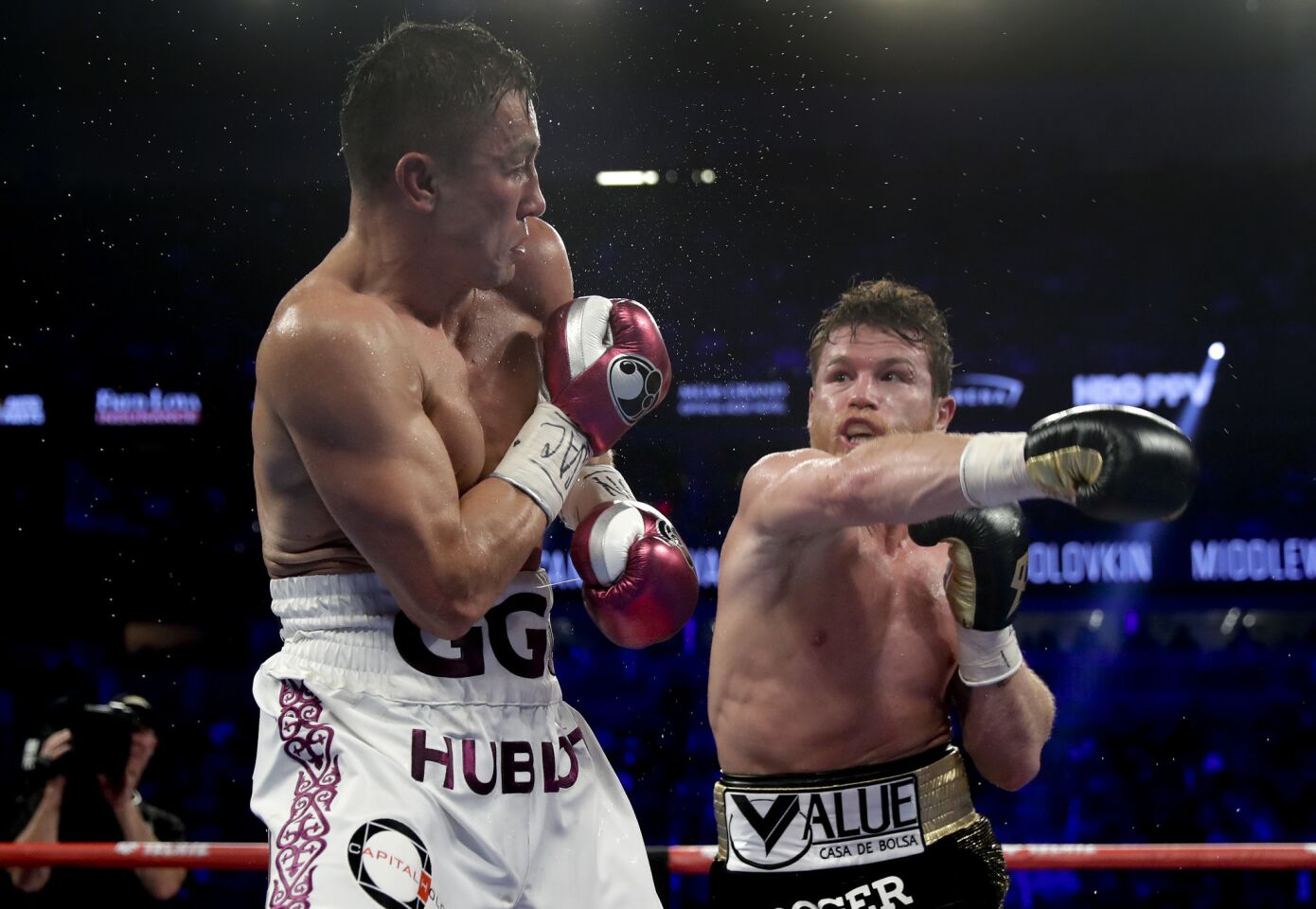 Gennady Golovkin, left, and Canelo Alvarez trade punches in the fifth round during a middleweight title boxing match, Saturday, Sept. 15, 2018, in Las Vegas.