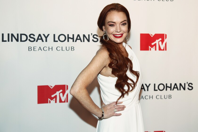 FILE - Lindsay Lohan attends MTV's "Lindsay Lohan's Beach Club" series premiere party at Magic Hour Rooftop at The Moxy Times Square on Jan. 7, 2019, in New York. Lohan is celebrating her 36th birthday on Saturday as a married woman. The “Freaky Friday” star said she was the “luckiest woman in the world” in an Instagram post Friday, July 1, 2022, that pictured her with financier Bader Shammas, who had been her fiance. (Photo by Andy Kropa/Invision/AP, File)