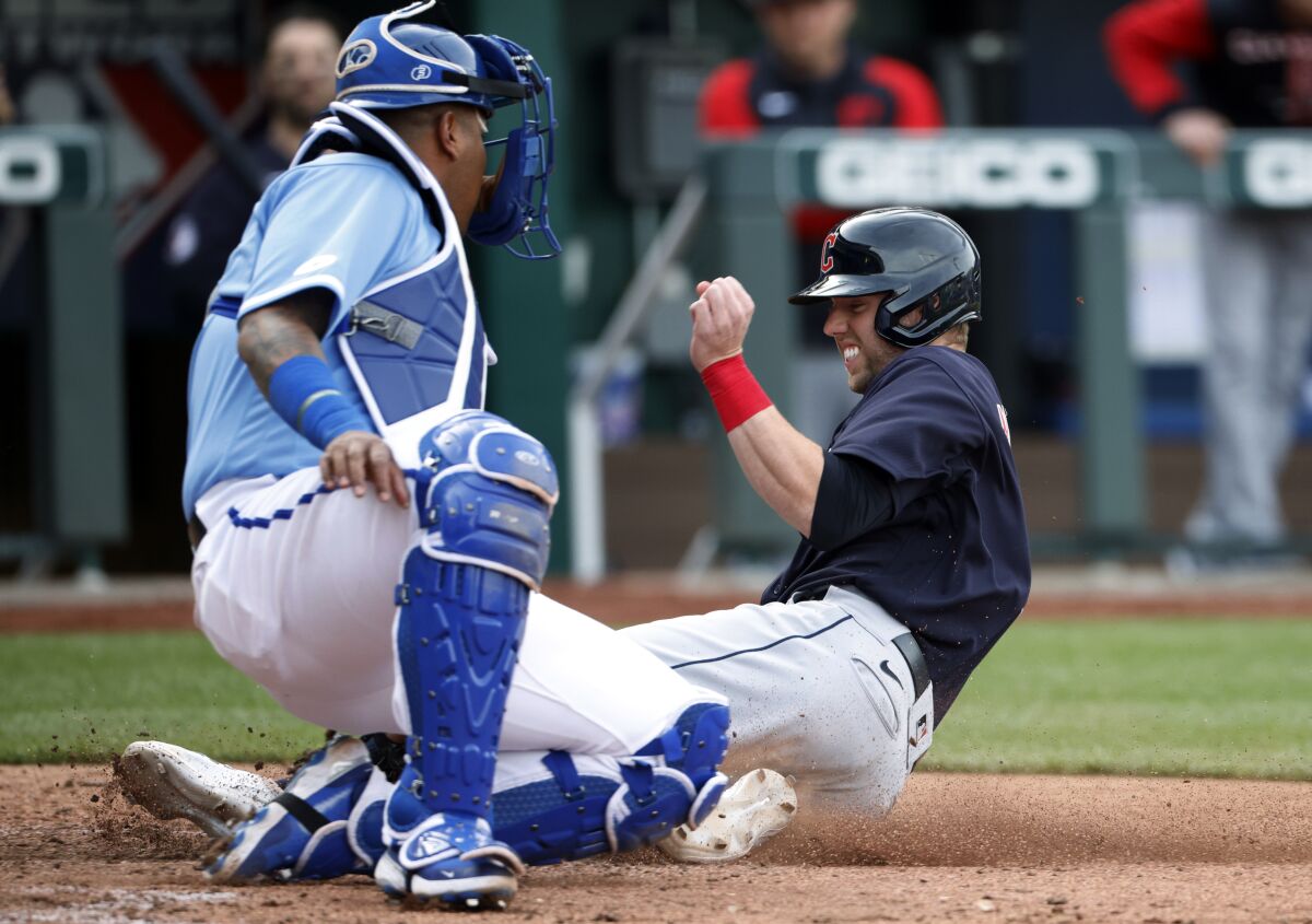 Kansas City Royals catcher Salvador Perez, left, tags out Cleveland Guardians' Owen Miller at home plate during the 10th inning of a baseball game in Kansas City, Mo., Saturday, April 9, 2022. (AP Photo/Colin E. Braley)