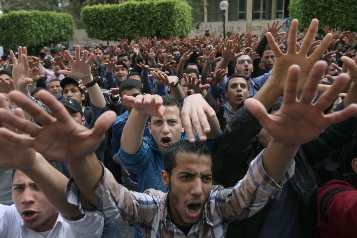 Egyptian students from Cairo University demonstrate in support of ousted Islamist President Mohamed Morsi. An Egyptian court sentenced 529 Morsi supporters to death in the killing of a police officer.