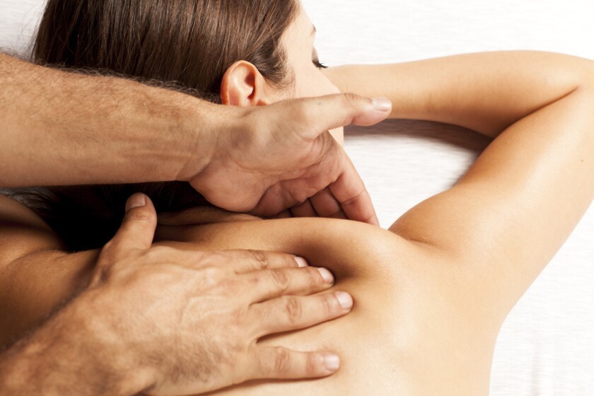 young woman enjoys back massage