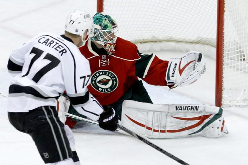 Minnesota Wild goalie Niklas Backstrom (32) stops a shot by Kings center Jeff Carter (77) during the first period.