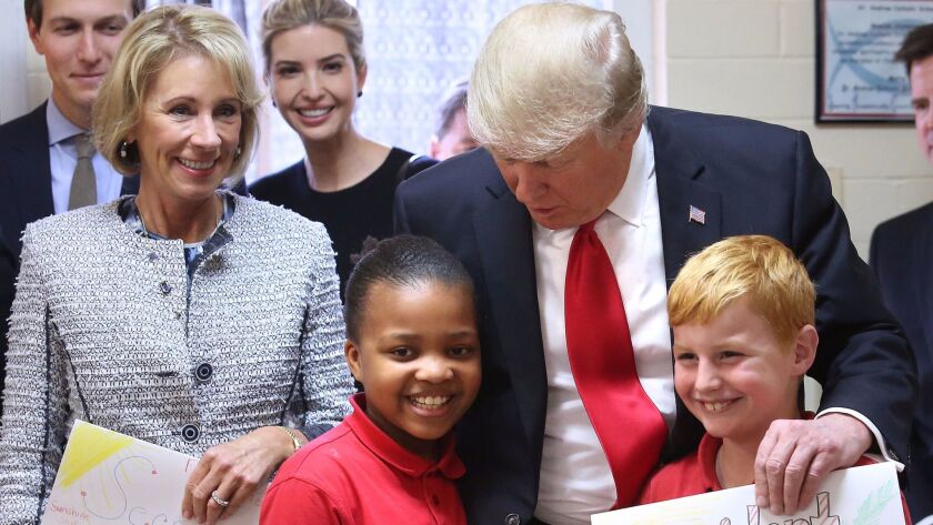 Secretary of Education Betsy DeVos and President Trump greet fourth-graders recently at St. Andrew Catholic School in Orlando, Fla., the kind of private school Californians might be willing to support with tax dollars.
