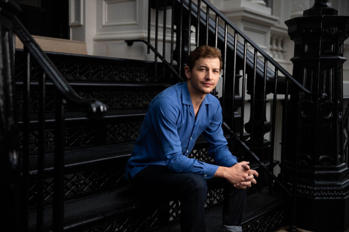 Actor Tye Sheridan sits on the stoop of a New York apartment building
