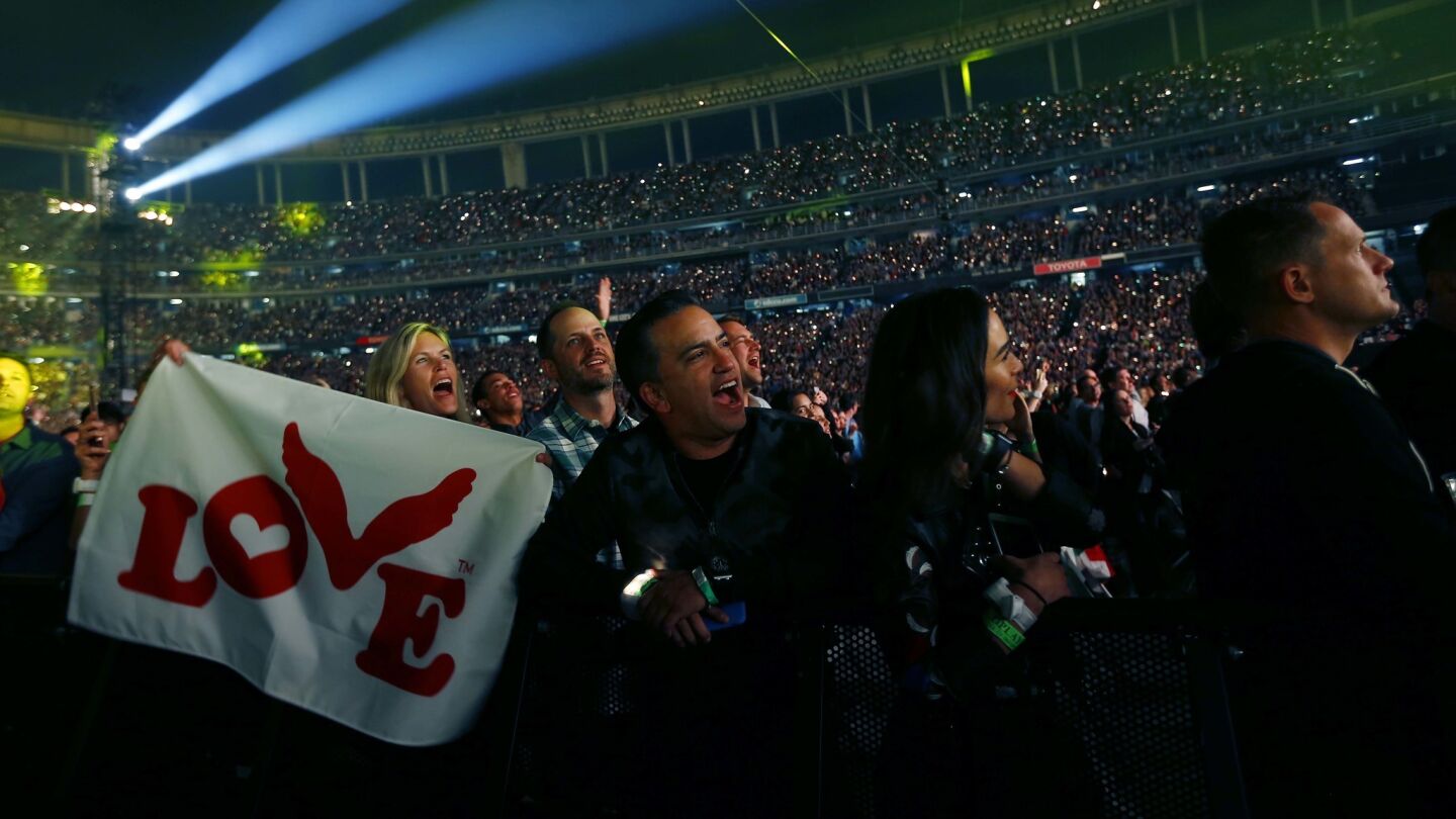 Fans look on as Coldplay performs during their A Head Full of Dreams Tour at SDCCU Stadium in San Diego on Oct. 8, 2017. (Photo by K.C. Alfred/The San Diego Union-Tribune)