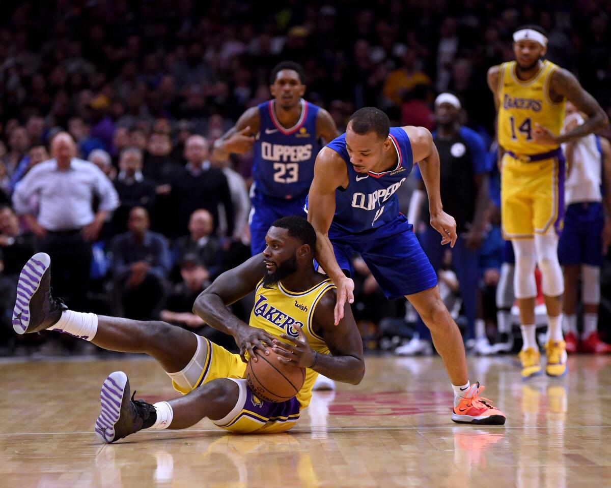 LOS ANGELES, CALIFORNIA - JANUARY 31: Lance Stephenson #6 of the Los Angeles Lakers tries to protect the ball from Avery Bradley #11 of the LA Clippers during a 123-120 Laker win at Staples Center on January 31, 2019 in Los Angeles, California. NOTE TO USER: User expressly acknowledges and agrees that, by downloading and or using this photograph, User is consenting to the terms and conditions of the Getty Images License Agreement. (Photo by Harry How/Getty Images) ** OUTS - ELSENT, FPG, CM - OUTS * NM, PH, VA if sourced by CT, LA or MoD **