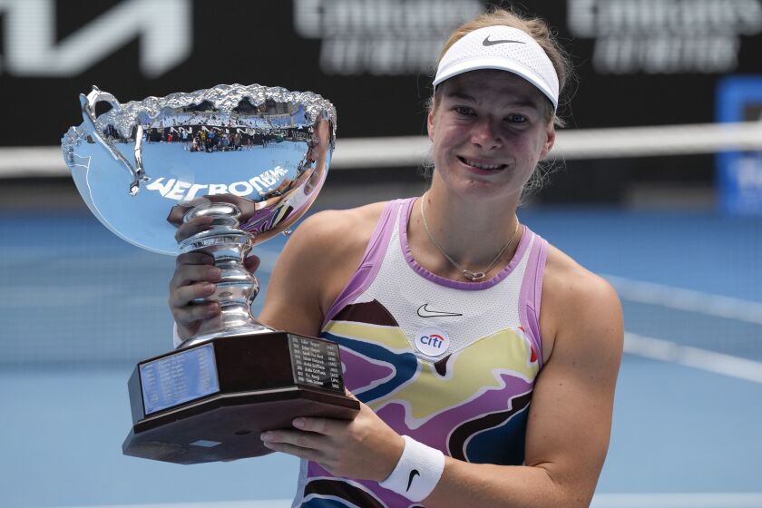 Diede de Groot of the Netherlands holds her trophy after defeating Yui Kamiji of Japan in the women's wheelchair final at the Australian Open tennis championship in Melbourne, Australia, Saturday, Jan. 28, 2023. (AP Photo/Ng Han Guan)