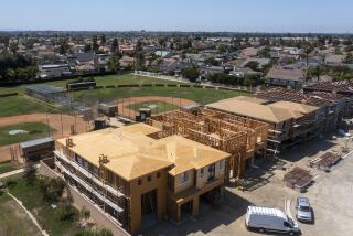 Huntington Beach, CA - August 09: An aerial view of workers constructing new homes at the LeBard Park and Residential Project in Huntington Beach on Monday, Aug. 9, 2021. (Allen J. Schaben / Los Angeles Times)