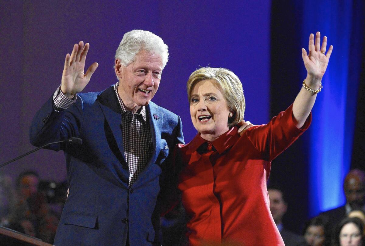 Bill and Hillary Clinton wave to supporters while celebrating Hillary's win in the Nevada caucus at Caesar's Palace Casino in Las Vegas on Feb. 20.