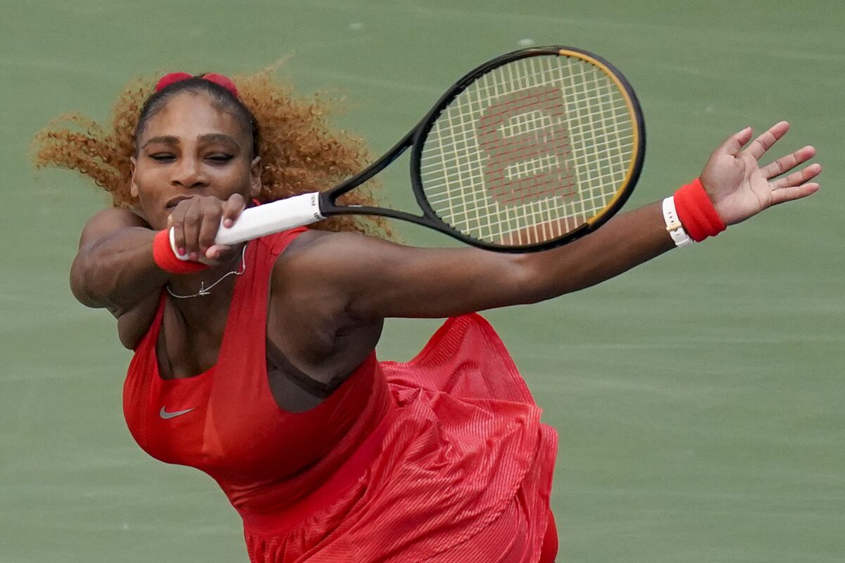 Serena Williams lunges to return a shot during a win over Sloane Stephens on Saturday at the U.S Open.