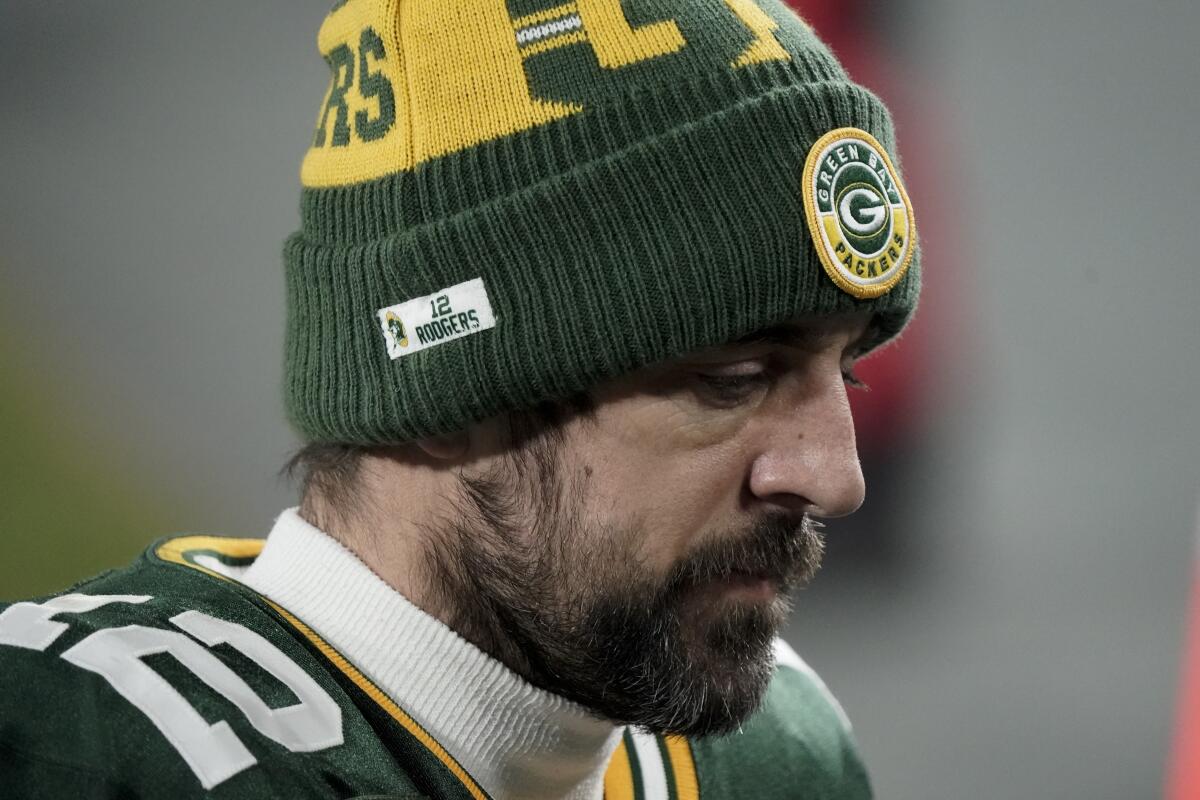 Aaron Rodgers wears a Packers uniform and hat after a game.