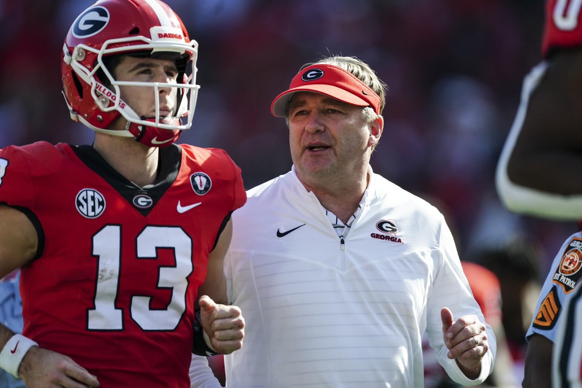 Georgia coach Kirby Smart runs off the field with quarterback Stetson Bennett during a win over Georgia Tech in November.