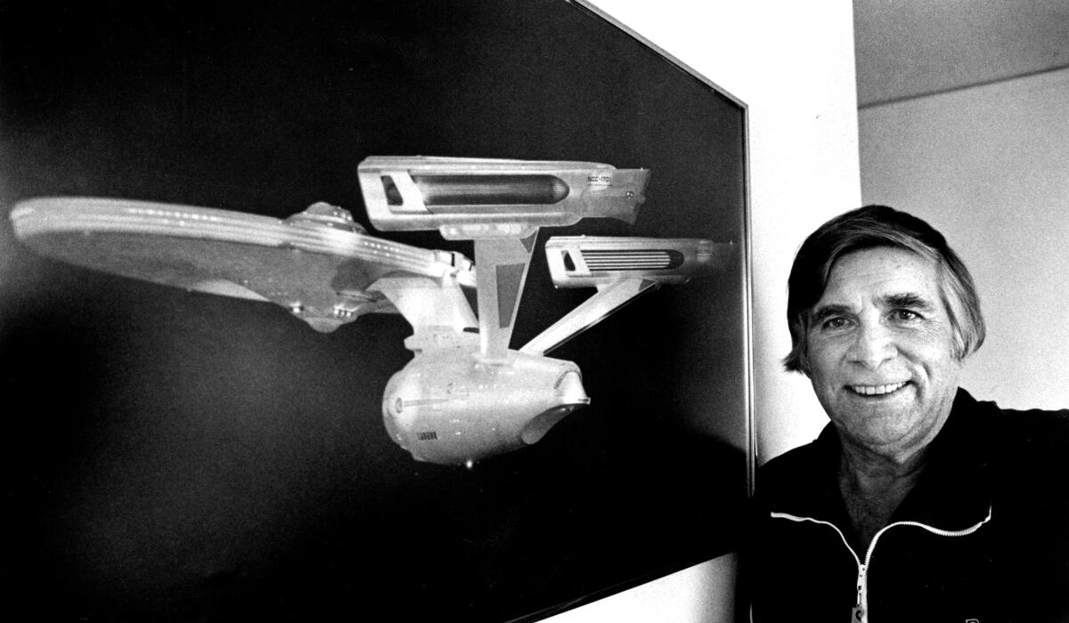 Gene Roddenberry, creator of "Star Trek," with an image of the starship Enterprise in 1984.