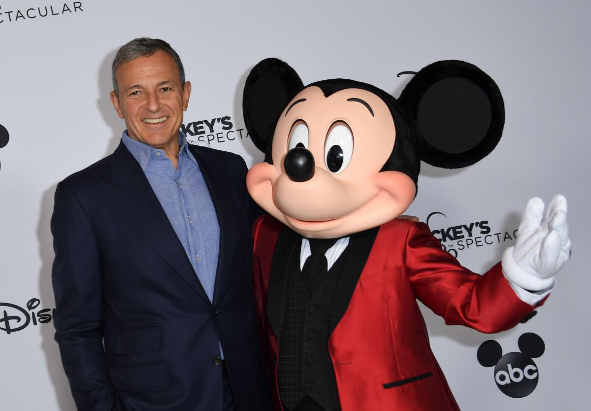 Disney Chief Executive Bob Iger  with Mickey Mouse at "Mickey's 90th Spectacular" at L.A.'s Shrine Auditorium in 2018.