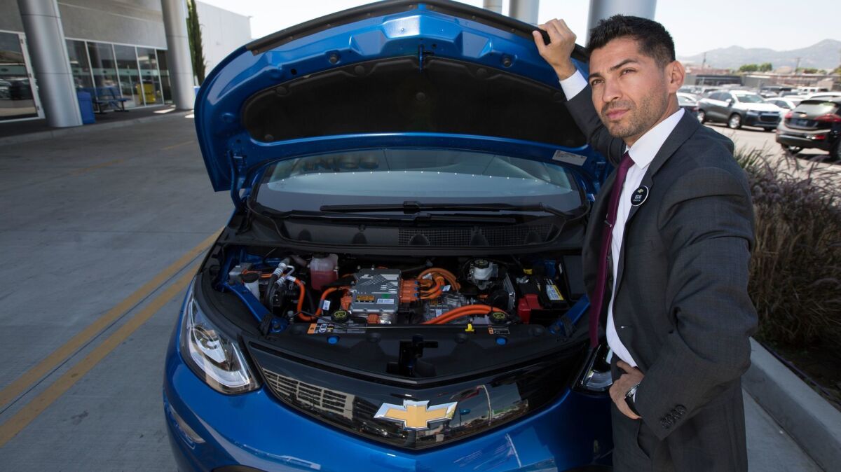 Oscar Gutierrez of Community Chevrolet in Burbank shows what's under the hood of a Bolt electric car.