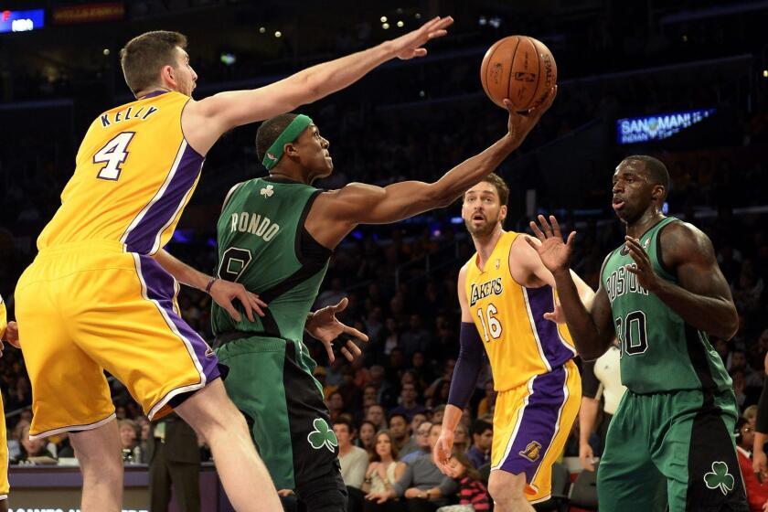 Lakers forward Ryan Kelly tries to block a reverse layup by Celtics point guard Rajon Rondo in the first half Friday night at Staples Center.