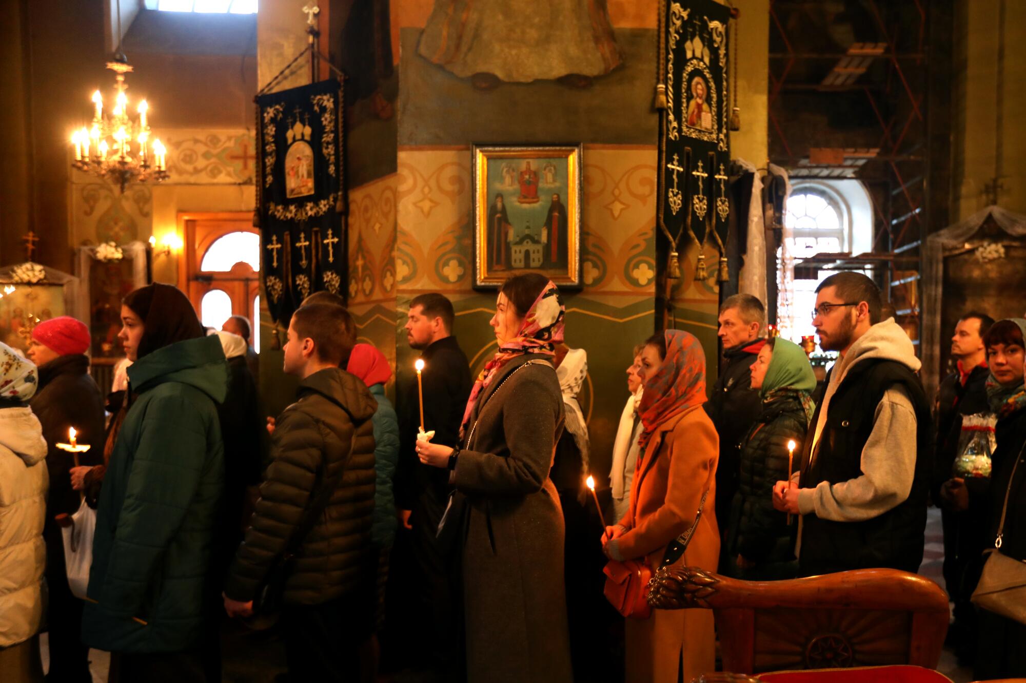Worshipers gathered at dawn, at the end of curfew, to celebrate Orthodox Christian Easter at Troitska Church