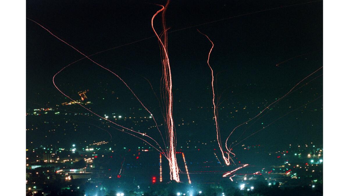 July 10, 1997: The lights of incoming and outgoing planes at Van Nuys Airport leave streaks of light in the night sky.