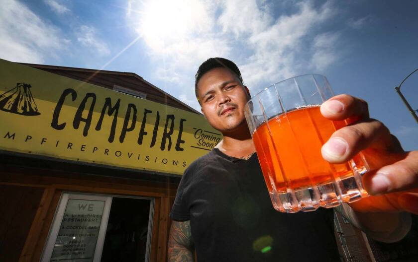 Bartender Leigh Lacap in front of Campfire in Carlsbad before its official opening.