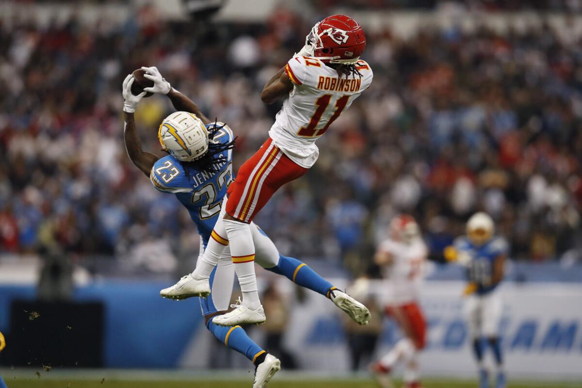 Chargers strong safety Rayshawn Jenkins intercepts a pass intended for Kansas City Chiefs wide receiver Demarcus Robinson.