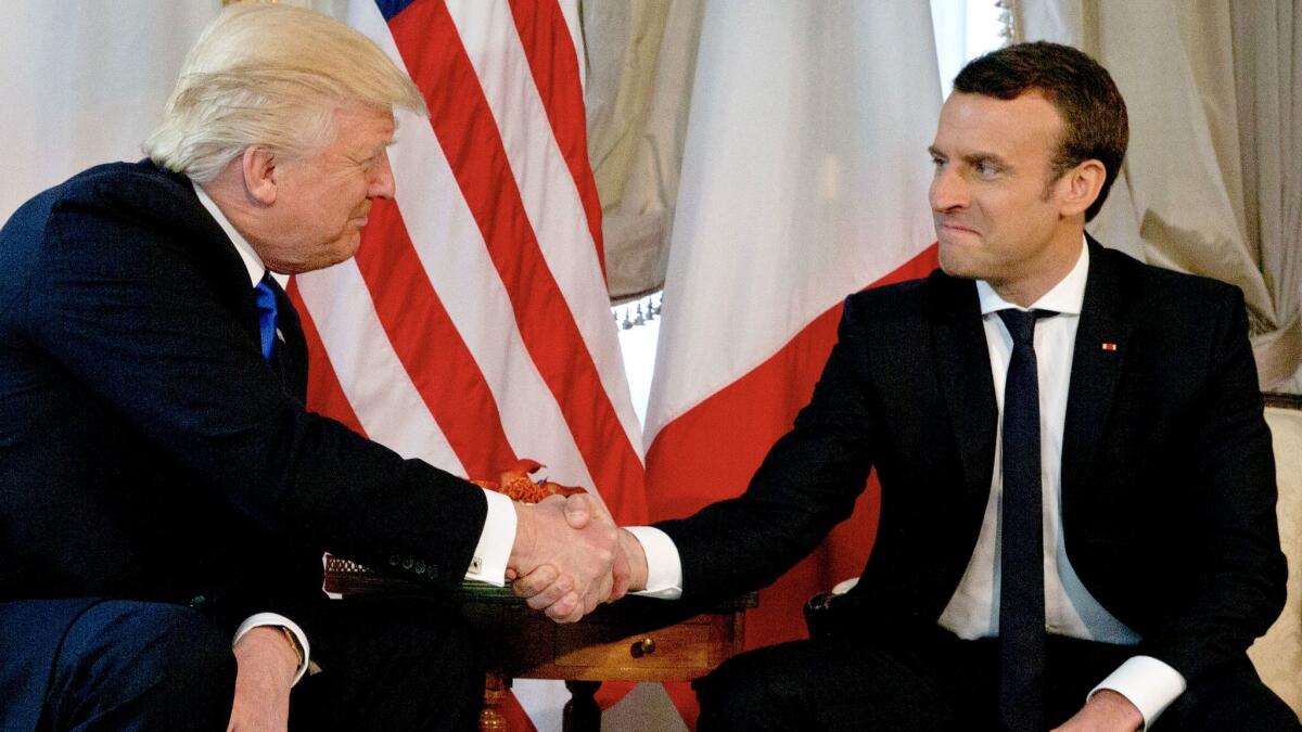 President Trump shakes hands with French President Emmanuel Macron.