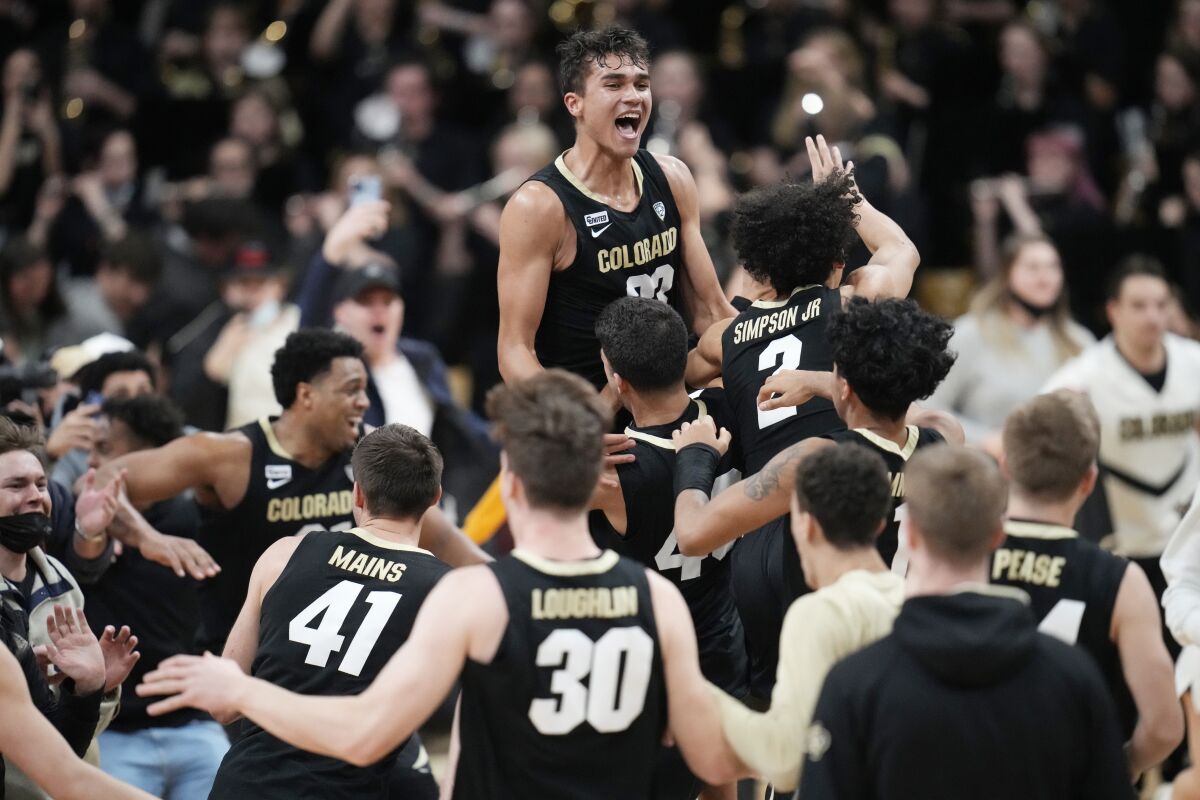 Colorado's Tristan da Silva, top, celebrates with teammates after an upset win over No. 2 Arizona on Feb. 26, 2022.