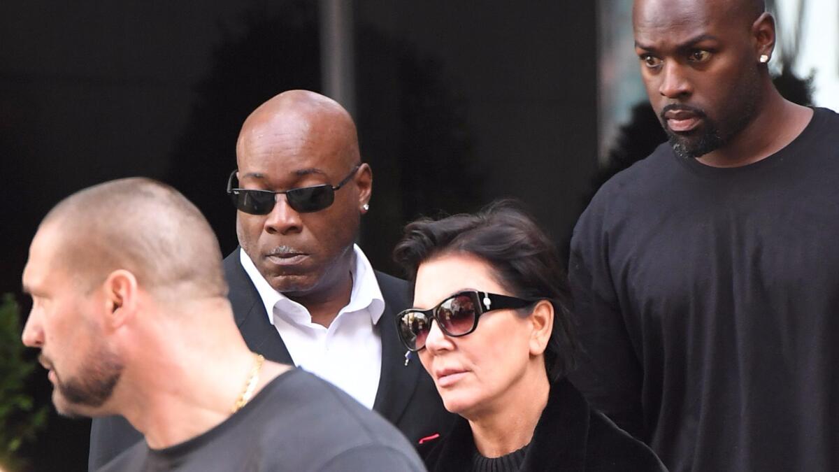 Guards accompany Kris Jenner and Kanye West in New York after Kim Kardashian was robbed at gunpoint in Paris.
