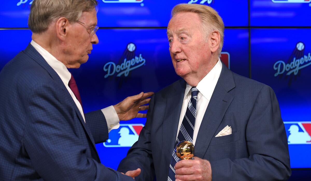 Baseball Commissioner Bud Selig presents Dodgers broadcaster Vin Scully with the Commissioner's Historic Achievement Award on Friday.